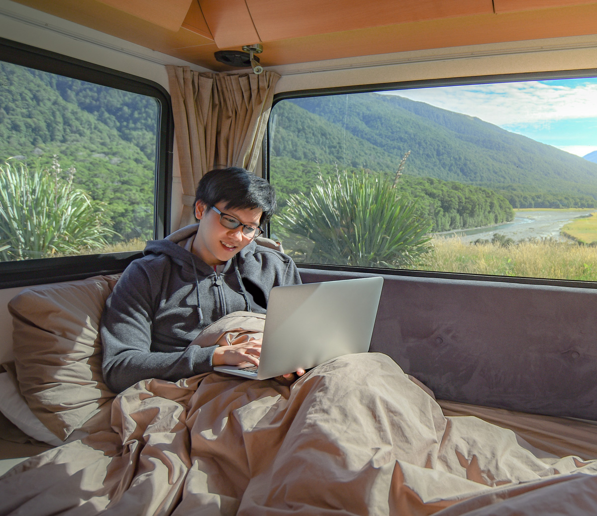 relaxing in camper with laptop