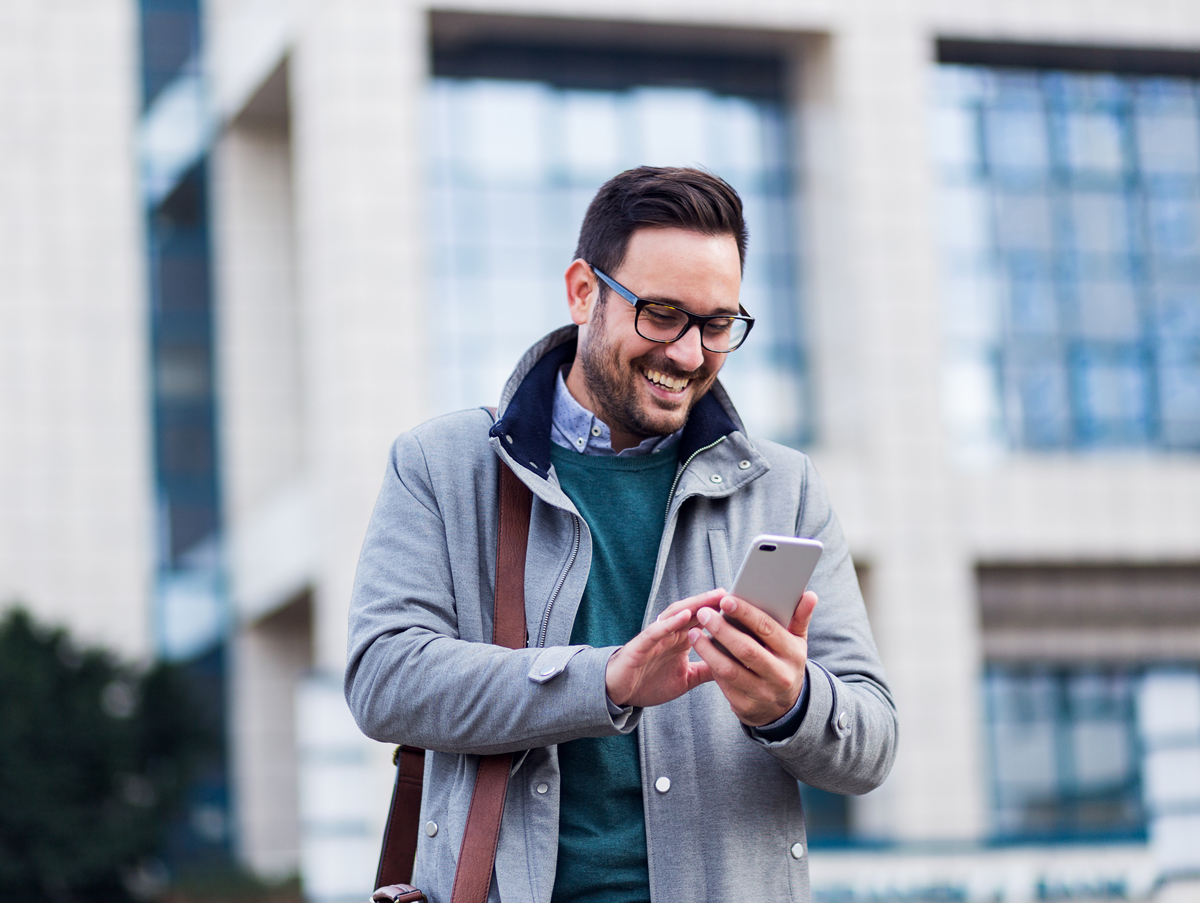 man-on-mobile-phone-outside-with-coat_228679121