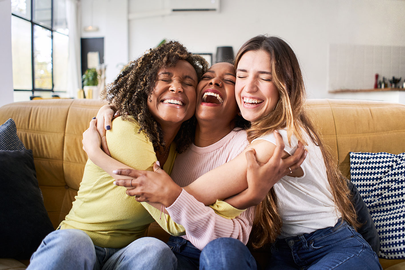 3 happy hugging women